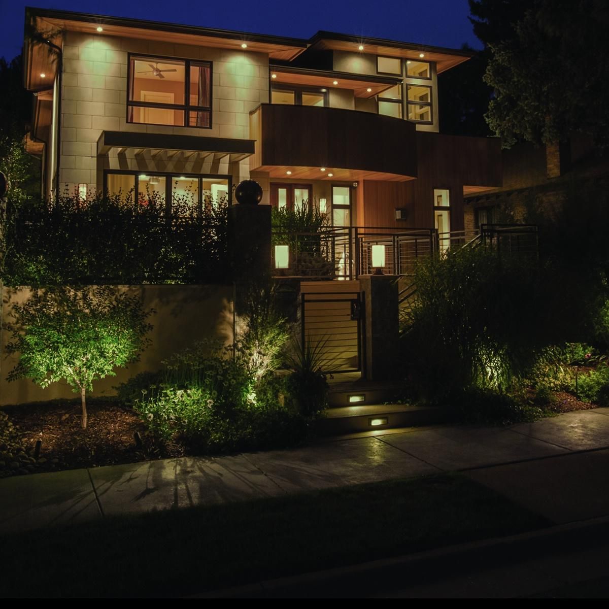 Large modern home lit up at dusk